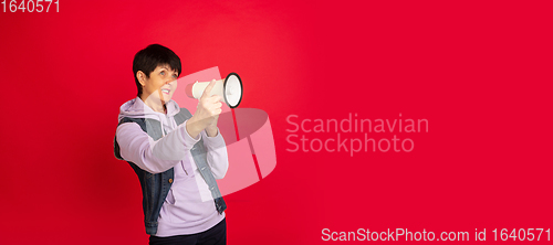 Image of Senior woman isolated on red background. Tech and joyful elderly lifestyle concept