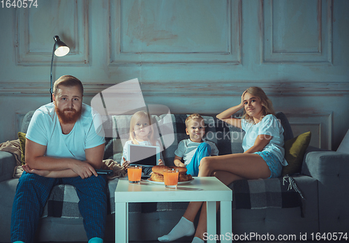 Image of Mother, father and kids at home having fun, comfort and cozy concept