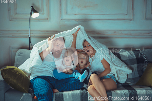Image of Mother, father and kids at home having fun, comfort and cozy concept