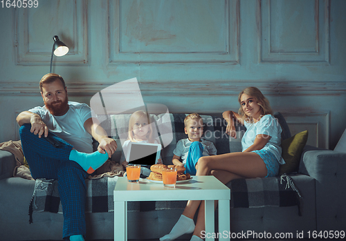 Image of Mother, father and kids at home having fun, comfort and cozy concept