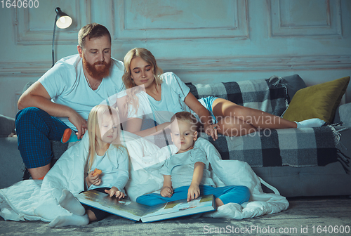 Image of Mother, father and kids at home having fun, comfort and cozy concept