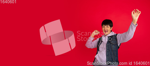 Image of Senior woman isolated on red background. Tech and joyful elderly lifestyle concept