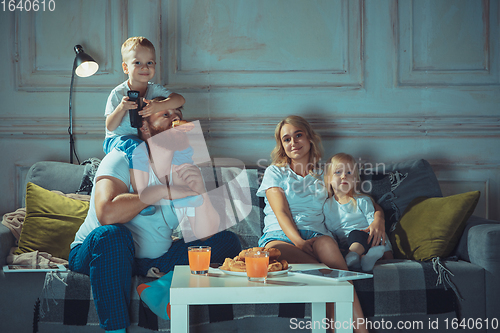 Image of Mother, father and kids at home having fun, comfort and cozy concept