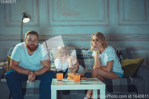 Image of Mother, father and kids at home having fun, comfort and cozy concept