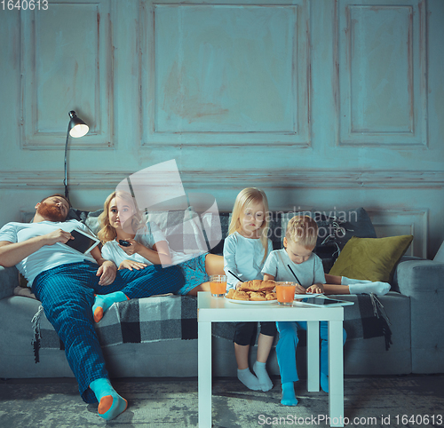 Image of Mother, father and kids at home having fun, comfort and cozy concept