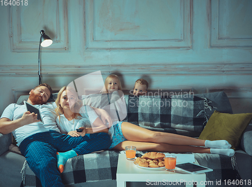 Image of Mother, father and kids at home having fun, comfort and cozy concept