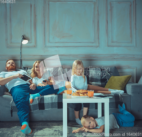 Image of Mother, father and kids at home having fun, comfort and cozy concept