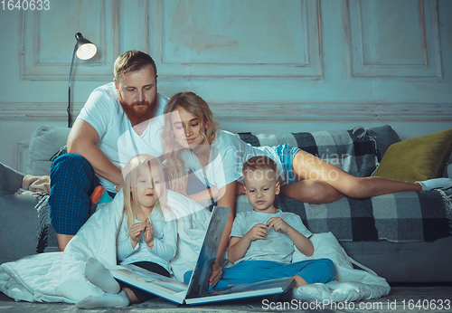 Image of Mother, father and kids at home having fun, comfort and cozy concept