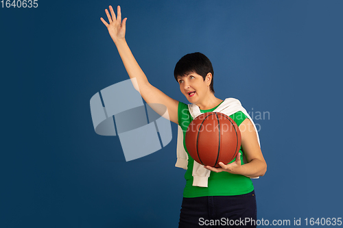 Image of Senior woman isolated on blue background. Tech and joyful elderly lifestyle concept