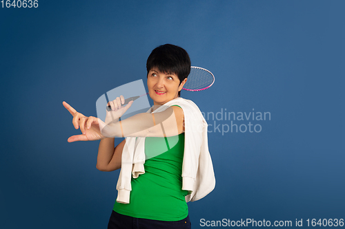Image of Senior woman isolated on blue background. Tech and joyful elderly lifestyle concept