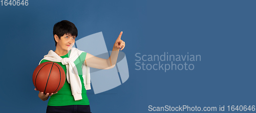 Image of Senior woman isolated on blue background. Tech and joyful elderly lifestyle concept