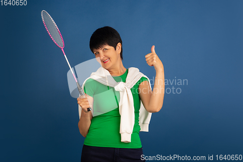 Image of Senior woman isolated on blue background. Tech and joyful elderly lifestyle concept