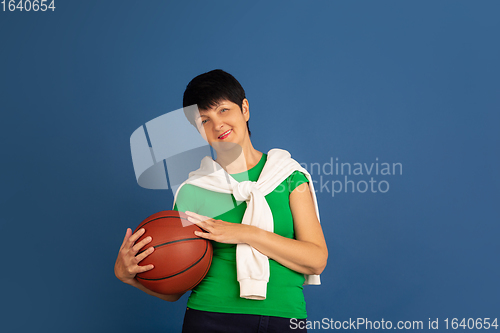 Image of Senior woman isolated on blue background. Tech and joyful elderly lifestyle concept
