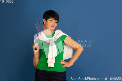 Image of Senior woman isolated on blue background. Tech and joyful elderly lifestyle concept