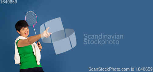 Image of Senior woman isolated on blue background. Tech and joyful elderly lifestyle concept