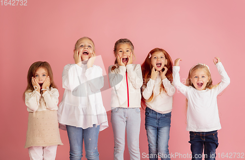 Image of Portrait of little caucasian children with bright emotions isolated on pink studio background