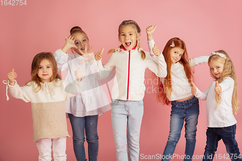 Image of Portrait of little caucasian children with bright emotions isolated on pink studio background