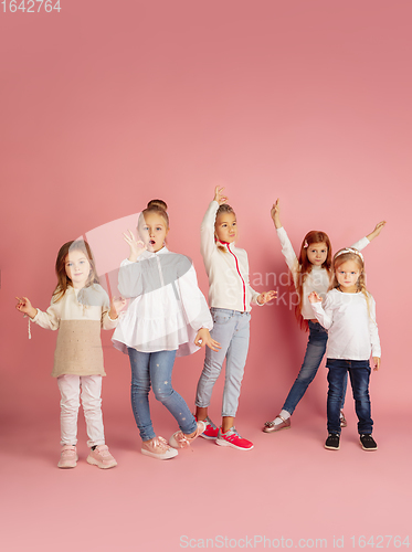 Image of Portrait of little caucasian children with bright emotions isolated on pink studio background