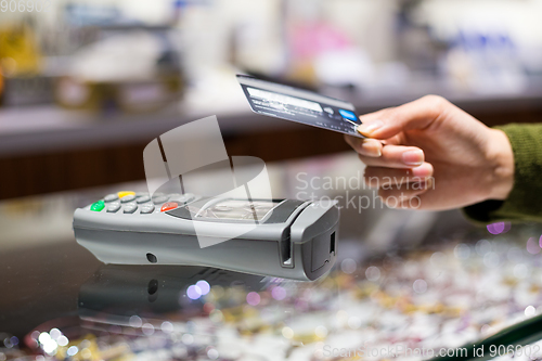 Image of Customer paying with NFC technology by credit card