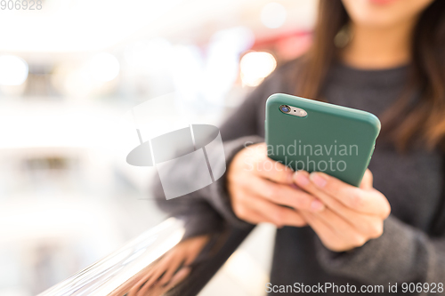 Image of Woman sending sms on mobile phone