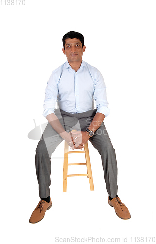 Image of Handsome Asian man sitting on chair
