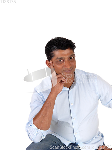 Image of Handsome man thinking with hand on face