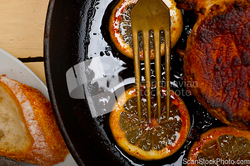 Image of pork chop seared on iron skillet