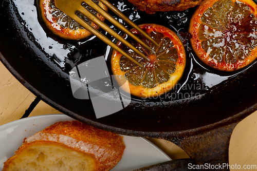 Image of pork chop seared on iron skillet