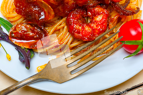 Image of Italian seafood spaghetti pasta on red tomato sauce