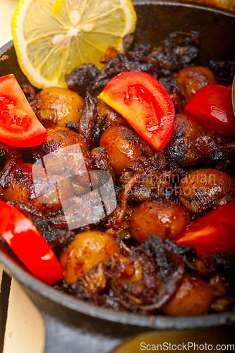 Image of Baby cuttle fish roasted on iron skillet