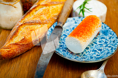 Image of French cheese and fresh  baguette on a wood cutter