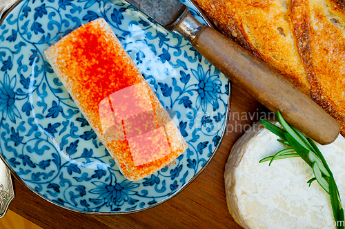 Image of French cheese and fresh  baguette on a wood cutter