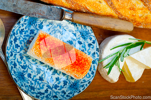 Image of French cheese and fresh  baguette on a wood cutter