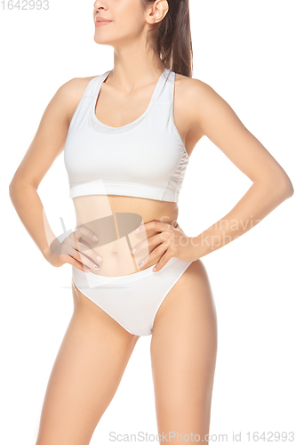 Image of Beautiful woman in underwear isolated on white background. Beauty, cosmetics, spa, depilation, diet, treatment and fitness concept, sensual posing