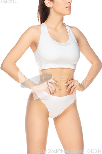 Image of Beautiful woman in underwear isolated on white background. Beauty, cosmetics, spa, depilation, diet, treatment and fitness concept, sensual posing