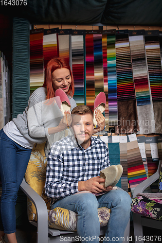 Image of Couple choosing textile at home decoration store, shop. Making of home interior design during quarantine