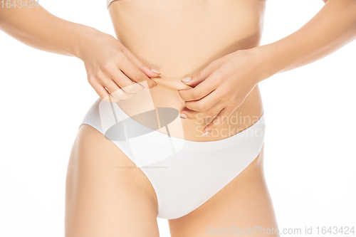 Image of Close up beautiful woman in underwear isolated on white background. Beauty, cosmetics, spa, depilation, diet, treatment and fitness concept, sensual posing