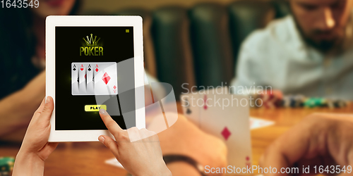 Image of Online gambling, casino concept. Hand holding device with lottery, casino cover