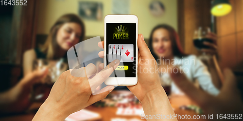 Image of Online gambling, casino concept. Hand holding device with lottery, casino cover