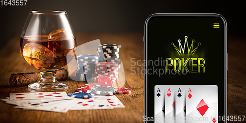 Image of Online gambling, casino concept. Hand holding device with lottery, casino cover