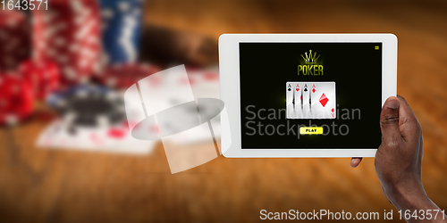 Image of Online gambling, casino concept. Hand holding device with lottery, casino cover