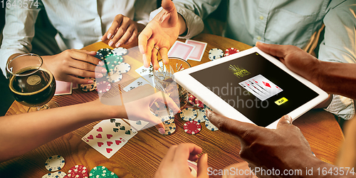 Image of Online gambling, casino concept. Hand holding device with lottery, casino cover