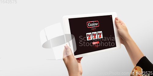 Image of Online gambling, casino concept. Hand holding device with lottery, casino cover