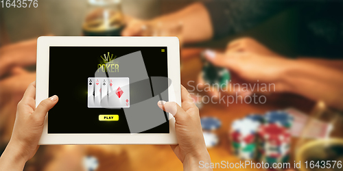 Image of Online gambling, casino concept. Hand holding device with lottery, casino cover