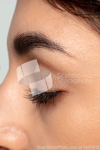 Image of Close up portrait of beautiful jewish woman isolated on studio background. Beauty, fashion, skincare, cosmetics concept. Details.