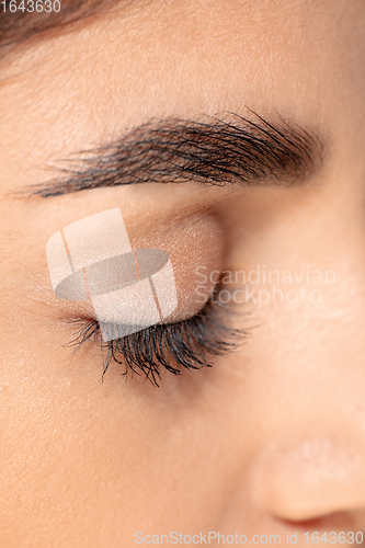 Image of Close up portrait of beautiful jewish woman isolated on studio background. Beauty, fashion, skincare, cosmetics concept. Details.