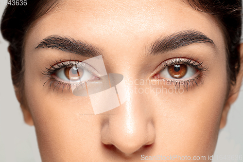 Image of Close up portrait of beautiful jewish woman isolated on studio background. Beauty, fashion, skincare, cosmetics concept. Details.