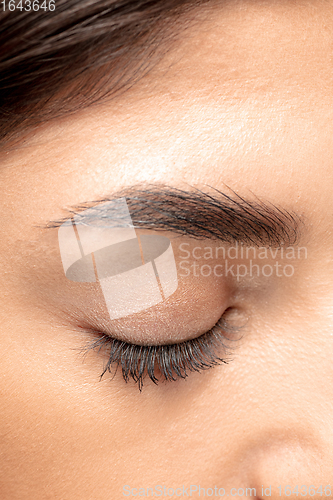 Image of Close up portrait of beautiful jewish woman isolated on studio background. Beauty, fashion, skincare, cosmetics concept. Details.