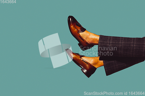 Image of Modern art collage in pop-art style. Legs in stylish shoes isolated on trendy colored background with copyspace, contrast