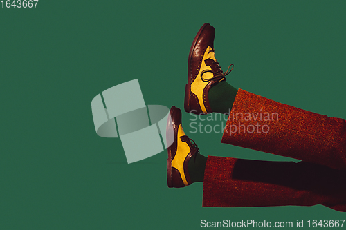 Image of Modern art collage in pop-art style. Legs in stylish shoes isolated on trendy colored background with copyspace, contrast